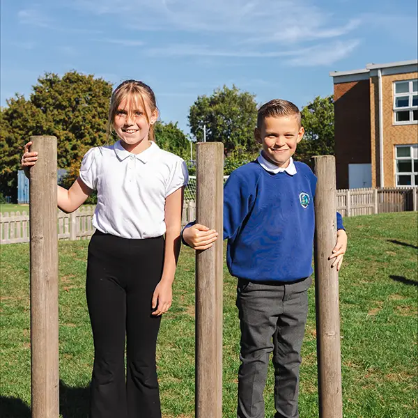 Two girls in school uniform in the playground